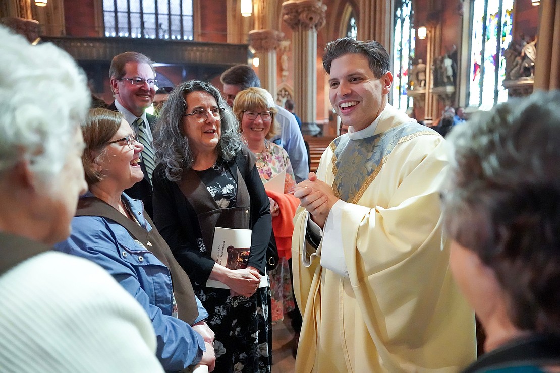 Newly ordained Father Alexander Turpin celebrates with family, friends and parishioners following the Mass of Ordination to the Priesthood and Diaconate on May 16 at the Cathedral of the Immaculate Conception in Albany. (Cindy Schultz photo for The Evangelist)