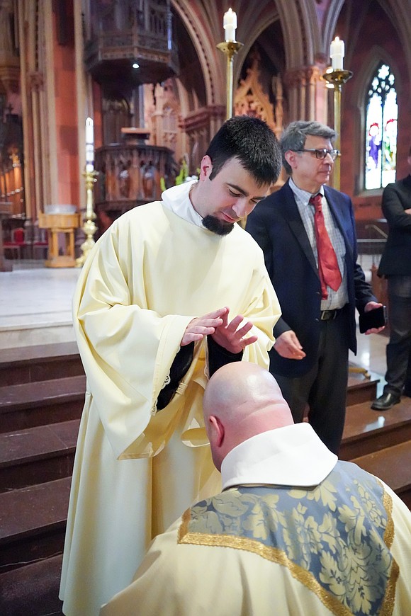Deacon Alessio Fasullo blesses Father Kyle Gorenski following the Mass of Ordination to the Priesthood and the Diaconate on May 16 at the Cathedral of the Immaculate Conception in Albany. (Cindy Schultz photo for The Evangelist)