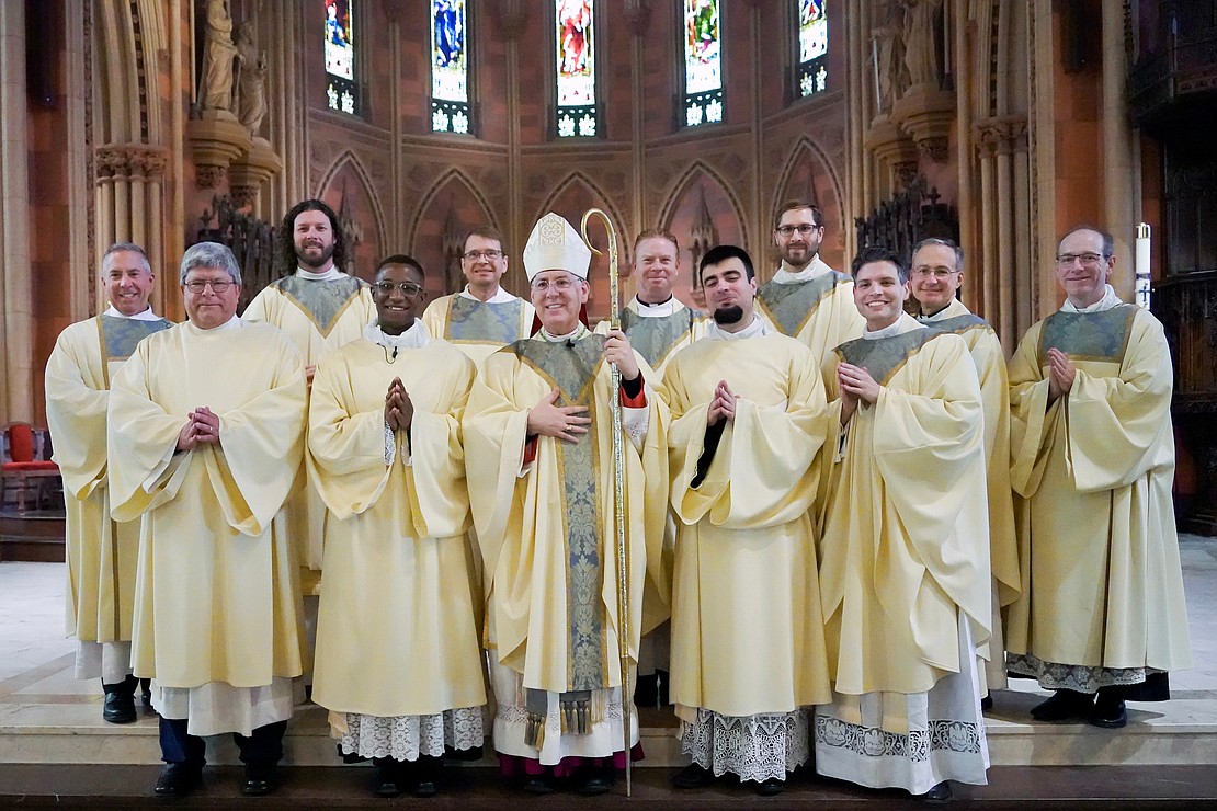 Newly ordained members of the priesthood and deaconship join members of the clergy for a picture with Bishop Mark O’Connell (c., front row) following the Mass of Ordination to the Priesthood and Diaconate on May 16 at the Cathedral of the Immaculate Conception in Albany. In the front row joining Bishop Mark are the newly ordained (from l.): Deacon Timothy Kilpeck, Deacon Gilbert Kimaro, Deacon Alessio Fasullo and Father Alexander Turpin. (Cindy Schultz photo for The Evangelist)