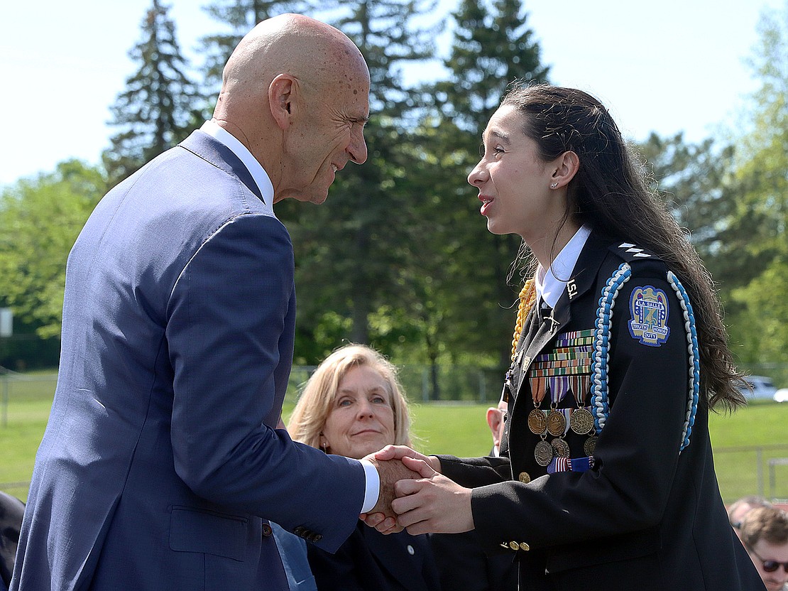 Valedictorian and Cadet Colonel Alara Crisafulli shakes hands with Brigadier General (Ret.) William Martin, Class of 1974, who delivered the address during La Salle Institute's 176th Commencement Ceremony on May 16. (Tom Killips photo)