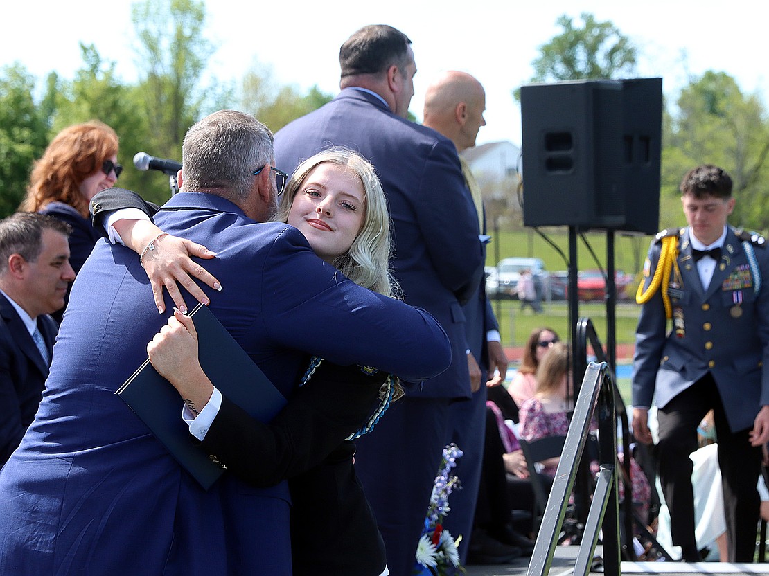 Shayna Heimroth hugs teacher Norman McAfee after receiving her diploma during La Salle Institute's 176th Commencement Ceremony on May 16. (Tom Killips photo)