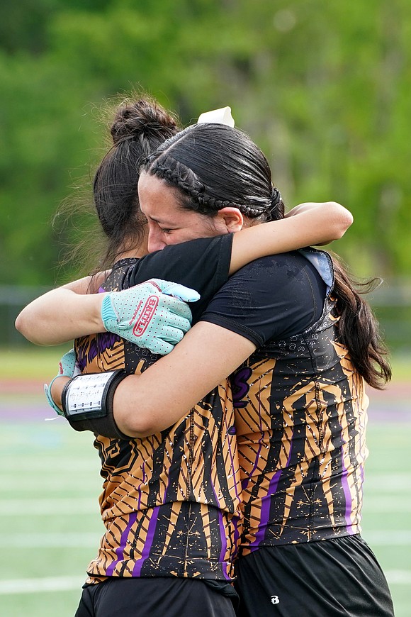 Holy Trinity’s Emma Sagendorf hugs Cassandra Padilla as they react to their 20-13 loss to Catskill during their Section 2 Class C flag football final on May 22 at Christian Brothers Academy. (Cindy Schultz photo for The Evangelist)
