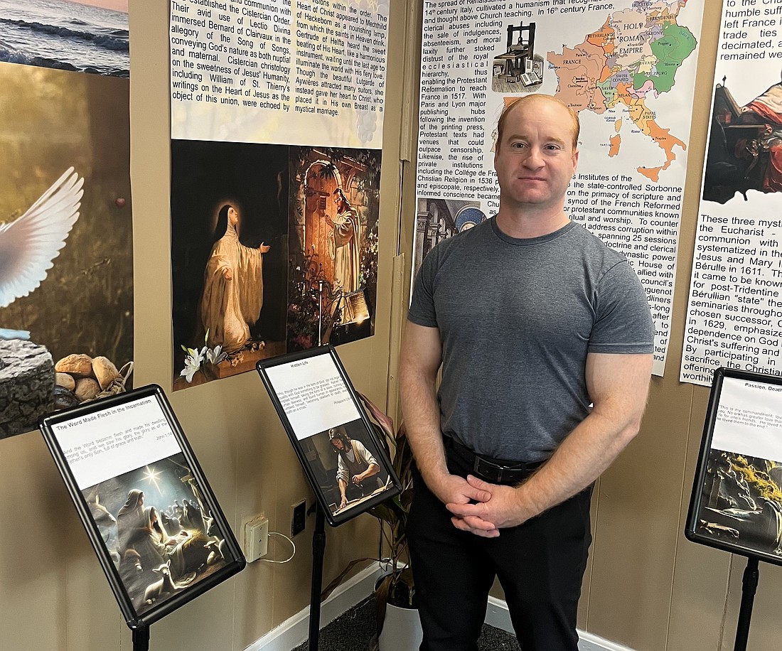 Stephen Dansereau, Faith Formation Director for Sacred Heart Church in Troy (below), stands inside the St. John Eudes Inner Sanctum, in the room displaying information on the theology and spirituality of the Sacred Heart of Christ. (Emily Benson photo)
