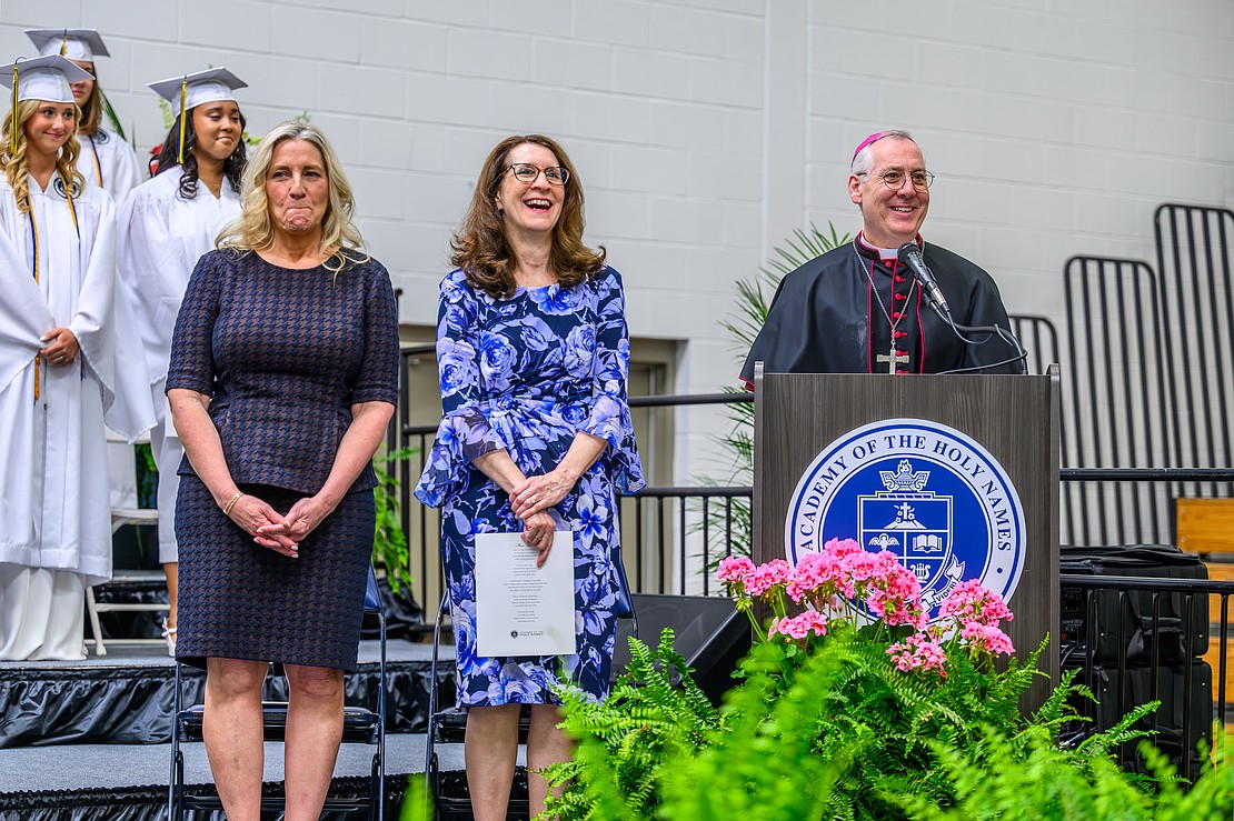 Bishop Mark 0’Connell, standing next to Principal Margaret Taranto and Keynote speaker and alumna Jennifer Corona, delivers the invocation during the commencement exercises on May 22 at the Academy of the Holy Names in Albany. (Vincent Giordano photo for The Evangelist)
