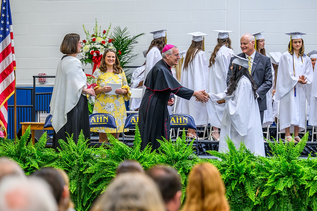 Graduate Erin Hockford shakes hands with Bishop Mark 0’Connell during the commencement exercises on May 22 at the Academy of the Holy Names in Albany. (Vincent Giordano photo for The Evangelist)