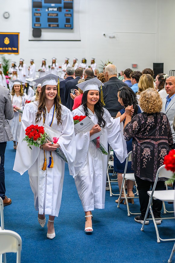 Graduates Georgia Boggs (l.) and Sabrina Masilotti lead the Class of 2026 out of the auditorium at the conclusion of commencement exercises on May 22 at the Academy of the Holy Names in Albany. (Vincent Giordano photo for The Evangelist)