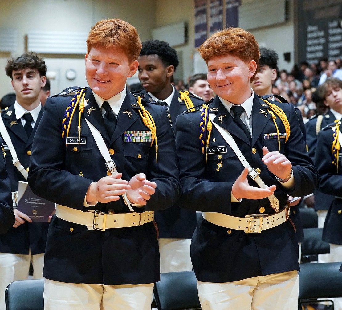 Graduates and twin brothers Ian Caldon (l.) and Isaac Caldon applaud after taking the alumni oath following their commencement exercises on May 29 at Christian Brothers Academy in Colonie. (Cindy Schultz photo for The Evangelist)
