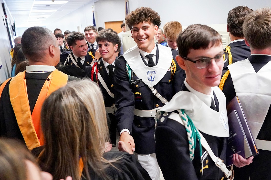 Graduate Christopher McLaughlin (c.) celebrates with teachers, staff and fellow graduates following their commencement exercises on May 29 at Christian Brothers Academy in Colonie. (Cindy Schultz photo for The Evangelist)