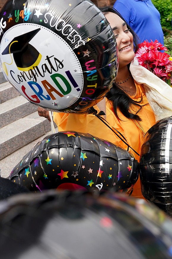Graduate Arianna Roopal is covered in balloons following the Notre Dame-Bishop Gibbons commencement exercises on June 6 at St. John the Evangelist in Schenectady. (Cindy Schultz photo for The Evangelist)