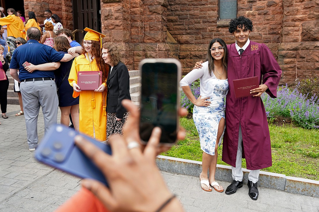 Graduate Nicholas Bholaisingh poses for pictures with his sister, Catherine, following the Notre Dame-Bishop Gibbons commencement exercises on June 6 at St. John the Evangelist in Schenectady. (Cindy Schultz photo for The Evangelist)