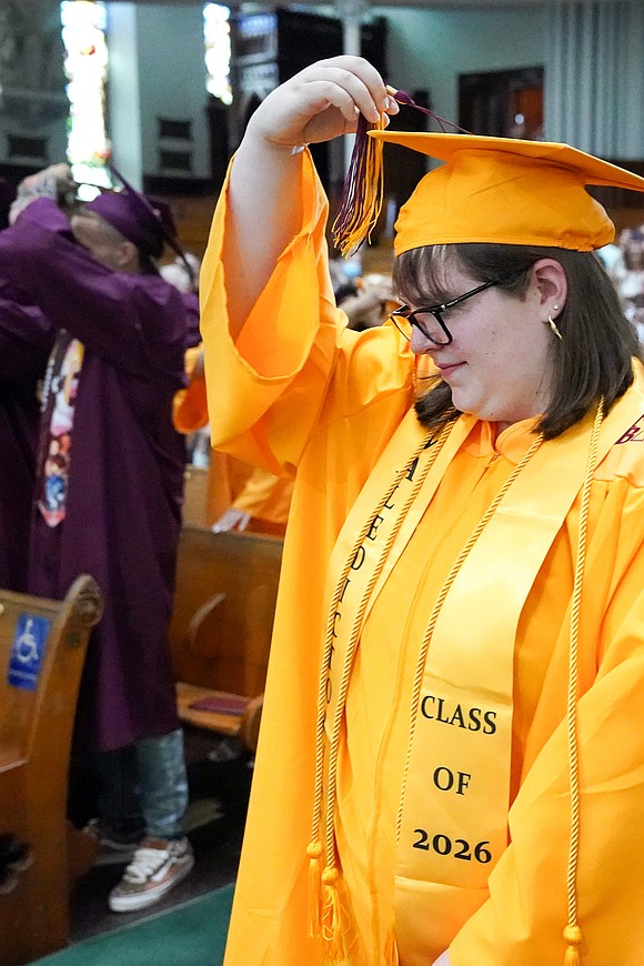 Valedictorian Emma Rucinski moves her tassel from right to left to reflect her graduate status during the Notre Dame-Bishop Gibbons commencement exercises on June 6 at St. John the Evangelist in Schenectady. (Cindy Schultz photo for The Evangelist)