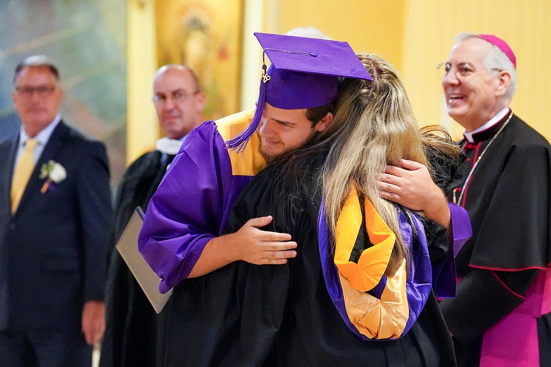 Graduate Aiden Farrell hugs his mother Tiffany Farrell, who’s the high school assistant principal, when he receives his diploma during Saratoga Catholic Central's commencement exercises on June 26 at St. Clement’s Church in Saratoga Springs. (Cindy Schultz photo for The Evangelist)