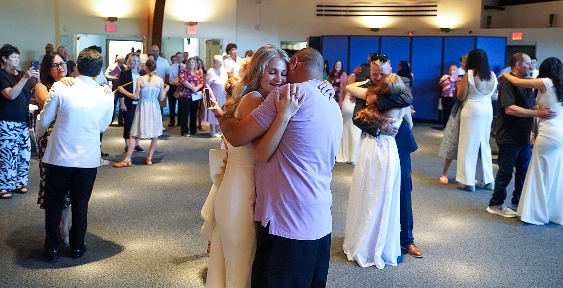 Graduate Allesandra Gross (c.) dances with her father, Phil, following Catholic Central School's commencement exercises on June 27 at St. Ambrose Church in Latham. (Cindy Schultz photo for The Evangelist)