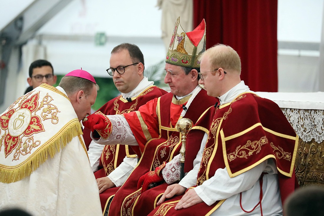Newly consecrated Society of St. Pius X Bishop Michael Goldade, an American, is seen kissing the ring of Bishop Alfonso de Galarreta during an SSPX liturgical celebration July 1, 2026, in Econe, Switzerland. The two bishops, along with with Bishop Bernard Fellay of SSPX and three other newly consecrated bishops were excommunicated by the Vatican July 2, as the consecration lacked the mandate of the pope and was decreed to be schismatic. (OSV News photo/CPP)