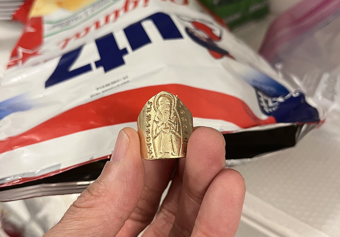 This is the photo that many Evangelist readers have probably seen on social media: Father Rendell Torres holding Bishop Mark’s ring after he found it in an Utz potato chip bag. (Photo courtesy of Bishop Mark O’Connell)