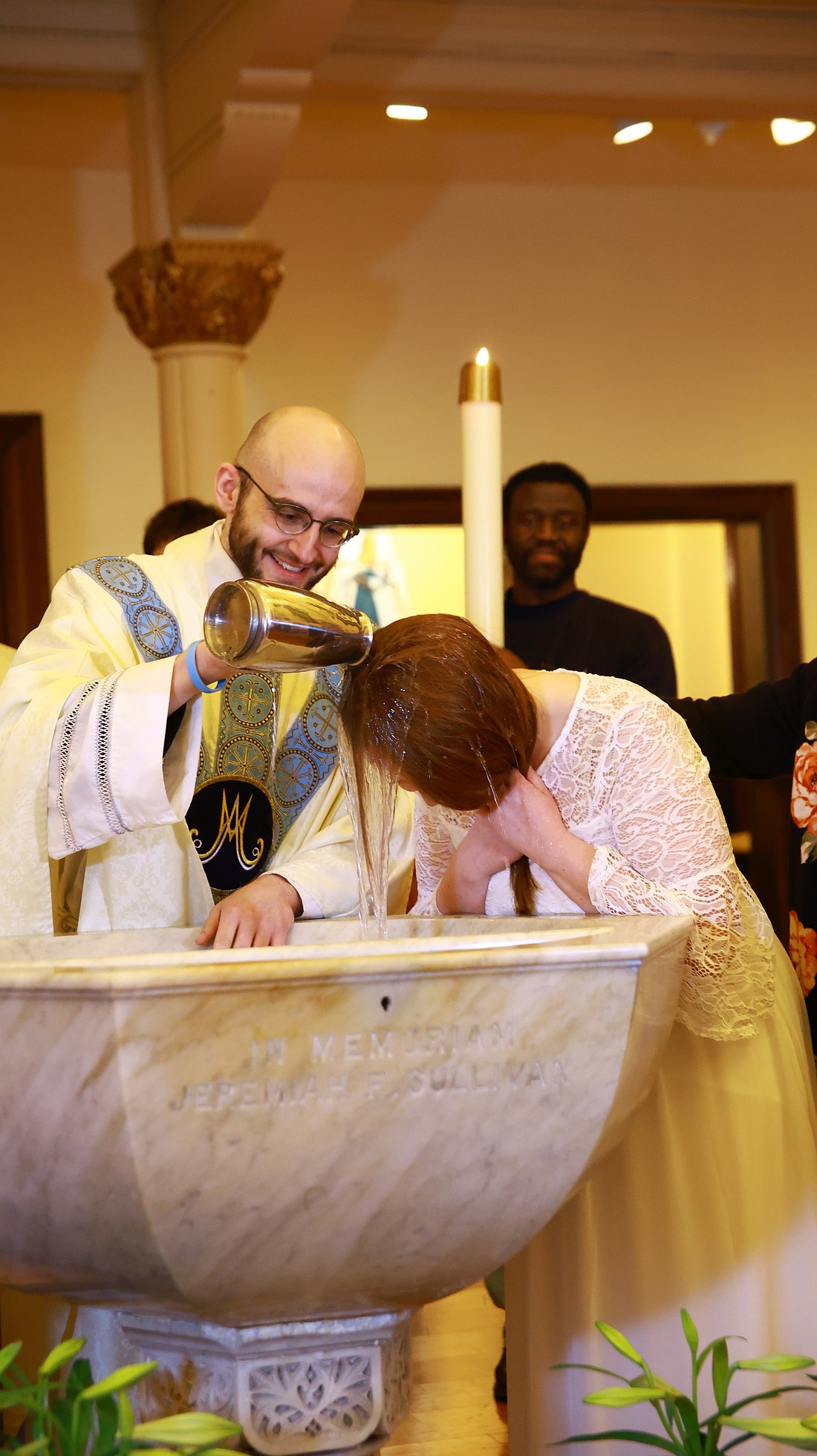 Father Samuel Bellafiore, shown during a baptism, said, “A lot of dioceses have been finding recently that if you assign a priest fulltime to vocations, you simply end up with more vocations.” (Photo provided)