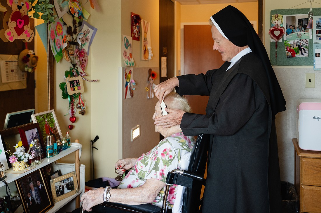 An undated photo shows a Carmelite sister coming a resident's hair at Ozanam Hall in Bayside the New York borough of Queens.  On July 30, 2026, a judge temporarily shielded four orders of women religious and Catholic healthcare ministries from enforcement of a New York state law allowing physicians to aid terminally ill adults in dying by suicide. (OSV News photo/courtesy Becket)