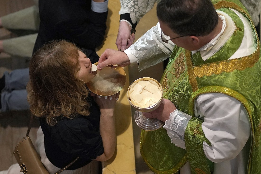 A worshipper receives Communion from Father James Miara, pastor of Holy Innocents Church in New York City, during a traditional Latin Mass at Holy Innocents July 13, 2025. (OSV News photo/Gregory A. Shemitz)