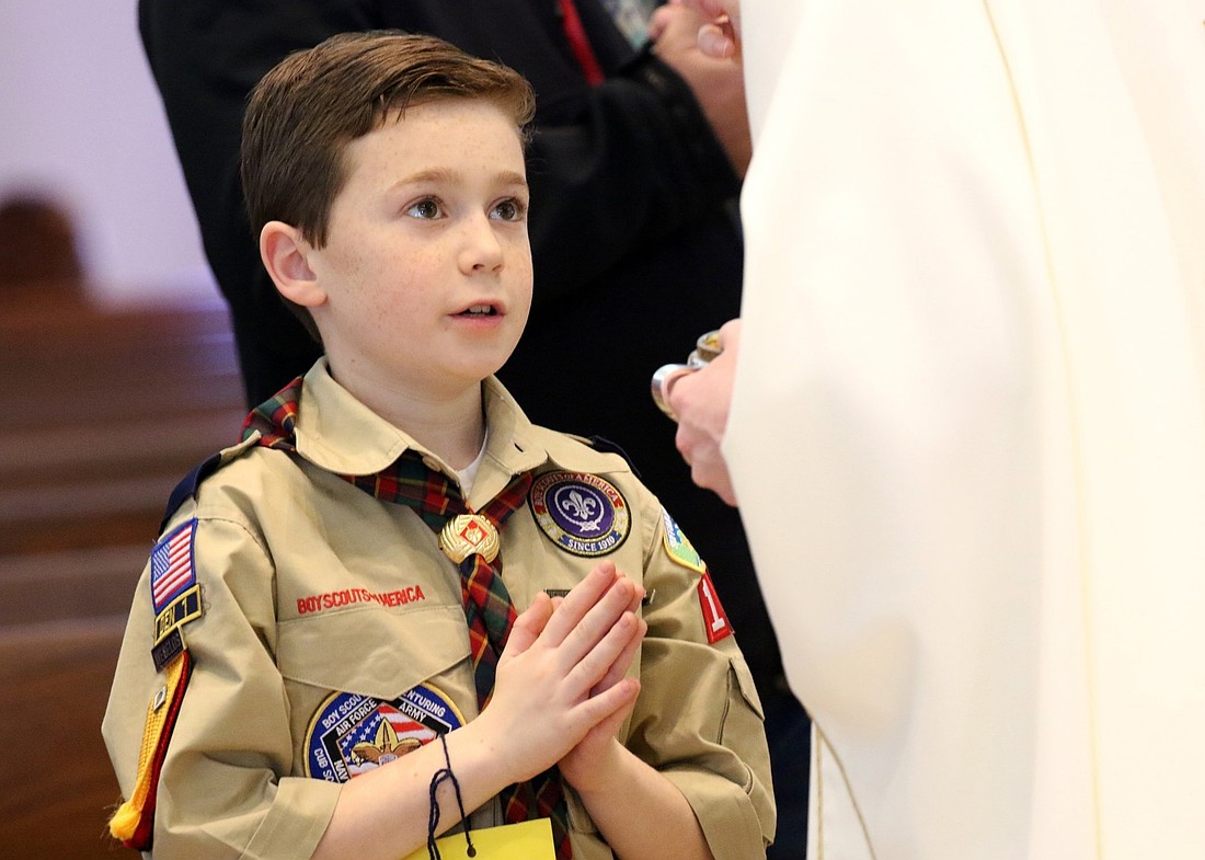 A Scout is pictured in a file photo receiving Communion during Mass while participating in Cub Scout Fun and Faith Day at St. Patrick Church in Smithtown, N.Y.  (OSV News photo/Gregory A. Shemitz, Long Island Catholic)