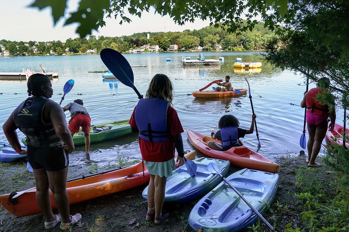 Campers launch their kayaks onto Snyder’s Lake on Aug. 4 at Camp Scully in Wynantskill. (Cindy Schultz photo for The Evangelist)