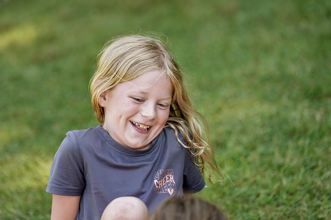 Kynlee McCollum, 8, laughs with a fellow camper on Aug. 4 at Camp Scully in Wynantskill. (Cindy Schultz photo for The Evangelist)