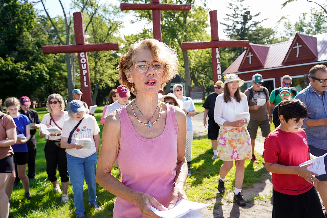 Tina Colliton of Schenectady, (c.), a parishioner at St. Kateri, joins in song at the start of the Pilgrimage for Peace on Saturday, Aug. 22. The event started at the National Shrine of the North American Martyrs in Auriesville. Participants, praying the rosary and singing songs, walked six miles to the Saint Kateri Tekakwitha National Shrine and Historic Site in Fonda. (Cindy Schultz photo for The Evangelist)