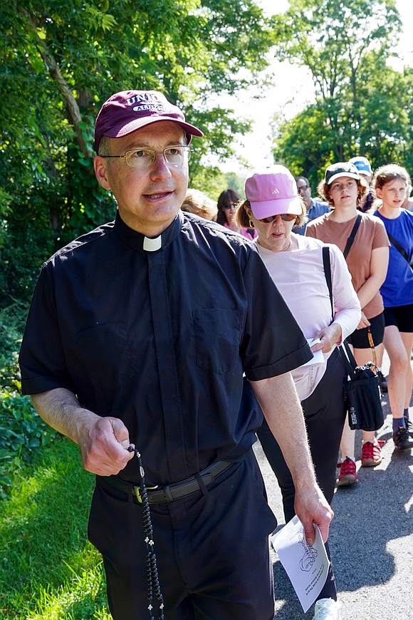 Father Tom Fallati leads participants in prayers of the rosary during the Pilgrimage for Peace on Saturday, Aug. 22. The event started at the National Shrine of the North American Martyrs in Auriesville. Participants, praying the rosary and singing songs, walked six miles to the Saint Kateri Tekakwitha National Shrine and Historic Site in Fonda. (Cindy Schultz photo for The Evangelist)