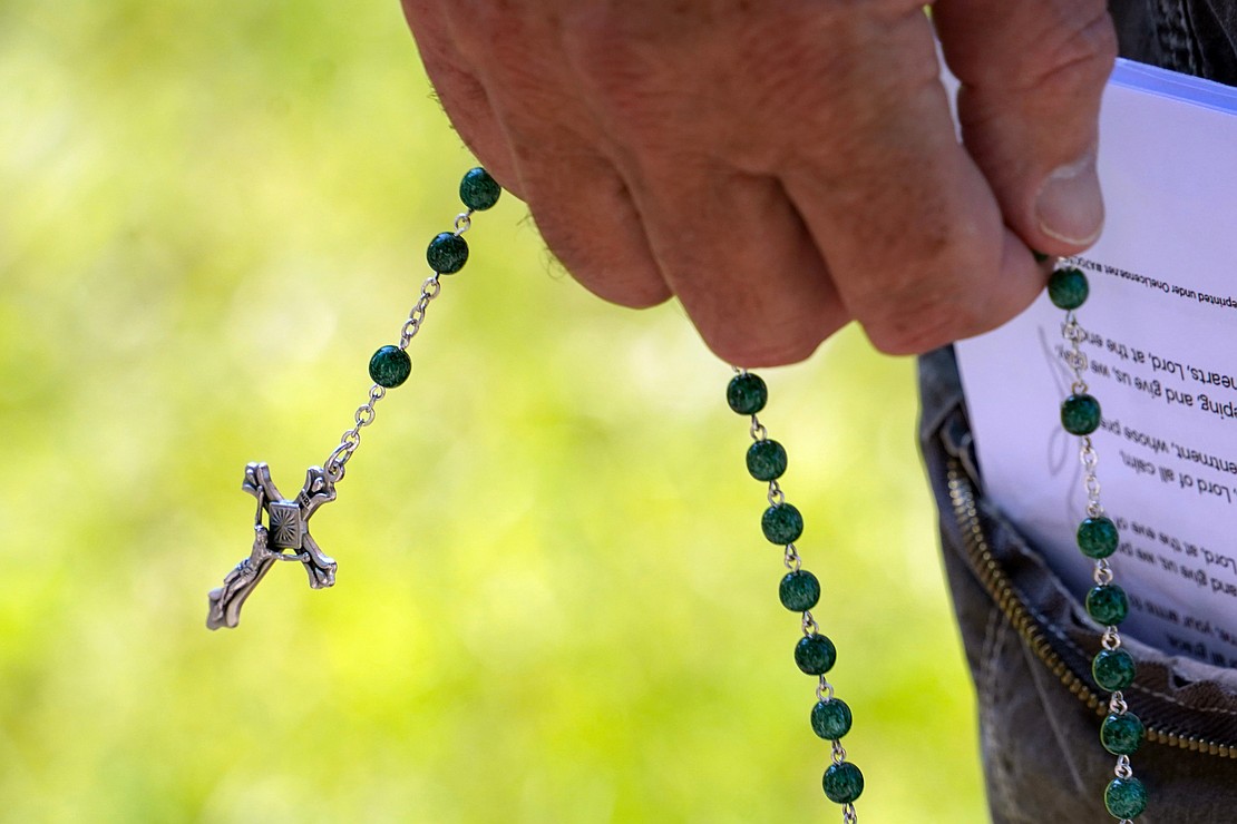 Participants carry rosaries and pray during the Pilgrimage for Peace on Saturday, Aug. 22. The event started at the National Shrine of the North American Martyrs in Auriesville. Participants, praying the rosary and singing songs, walked six miles to the Saint Kateri Tekakwitha National Shrine and Historic Site in Fonda. (Cindy Schultz photo for The Evangelist)