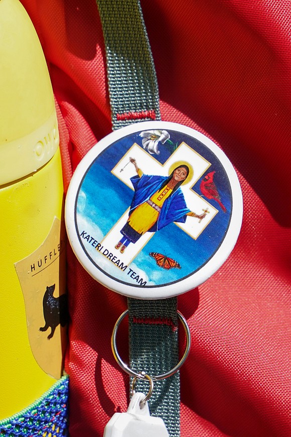 A Saint Kateri button is seen on a backpack as participants walk along the Erie Canalway Trail to the Saint Kateri Tekakwitha National Shrine and Historic Site during the Pilgrimage for Peace on Saturday, Aug. 22, in Montgomery County.  (Cindy Schultz photo for The Evangelist)