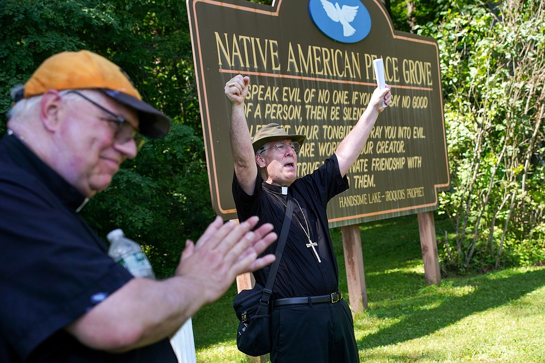Bishop Mark O’Connell celebrates with Father Bob Longobucco when they arrive at their destination during the Pilgrimage for Peace on Saturday, Aug. 22. The event started at the National Shrine of the North American Martyrs in Auriesville. Participants, praying the rosary and singing songs, walked six miles to the Saint Kateri Tekakwitha National Shrine and Historic Site in Fonda. (Cindy Schultz photo for The Evangelist)