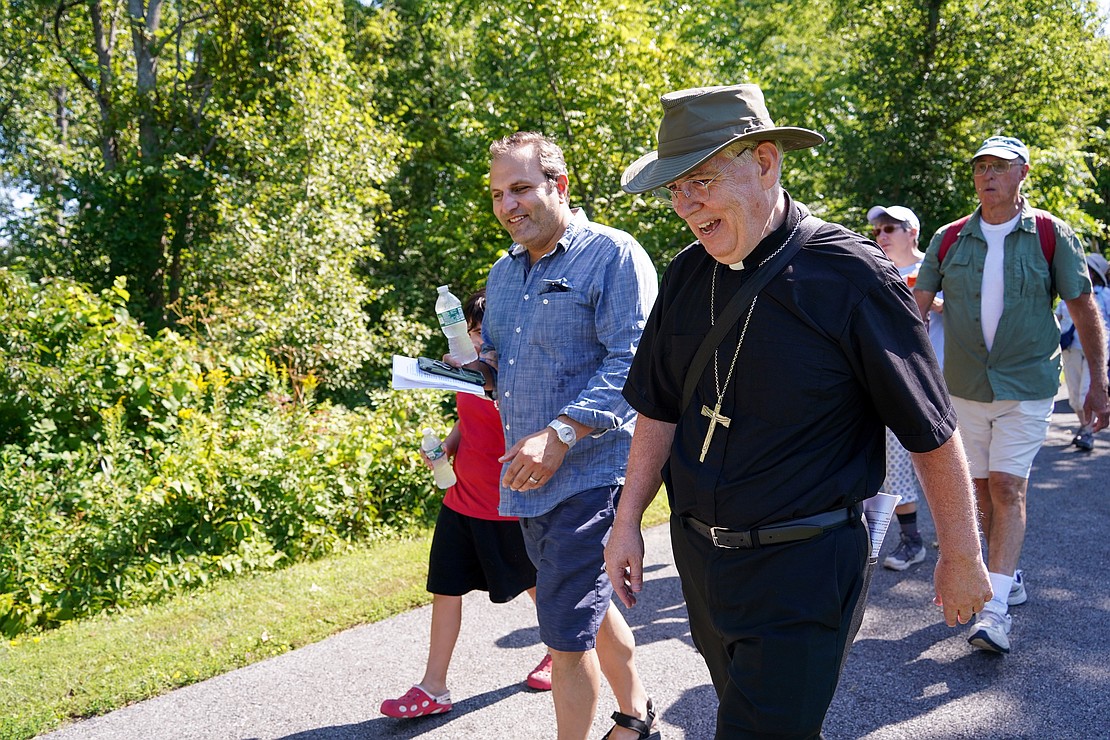 Bishop Mark O’Connell walks with Remo Muscedere of Glenville, a parishioner at St. Anthony, during the Pilgrimage for Peace on Saturday, Aug. 22. The event started at the National Shrine of the North American Martyrs in Auriesville. Participants walked six miles to the Saint Kateri Tekakwitha National Shrine and Historic Site in Fonda. (Cindy Schultz photo for The Evangelist)