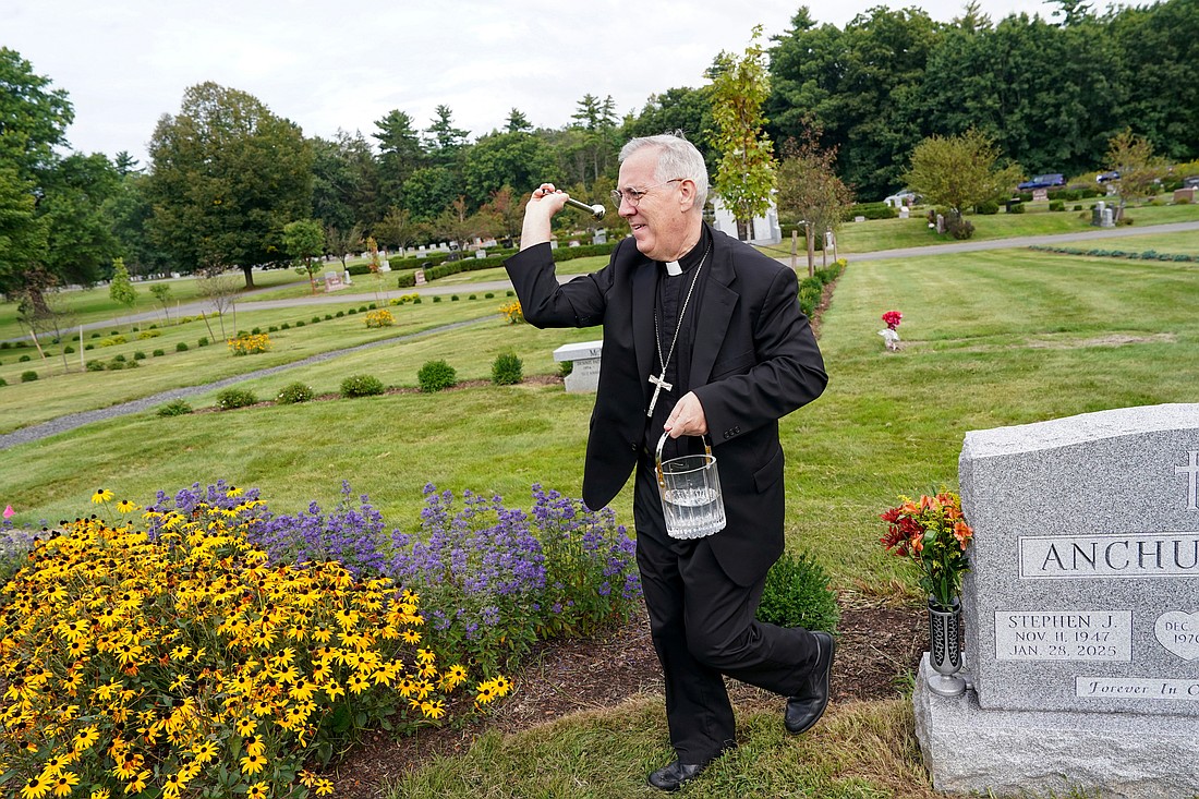Bishop Mark O’Connell scatters holy water as he blesses the Holy Family Garden III on Wednesday, Sept. 9, at Most Holy Redeemer Cemetery in Niskayuna. (Cindy Schultz photo for The Evangelist)