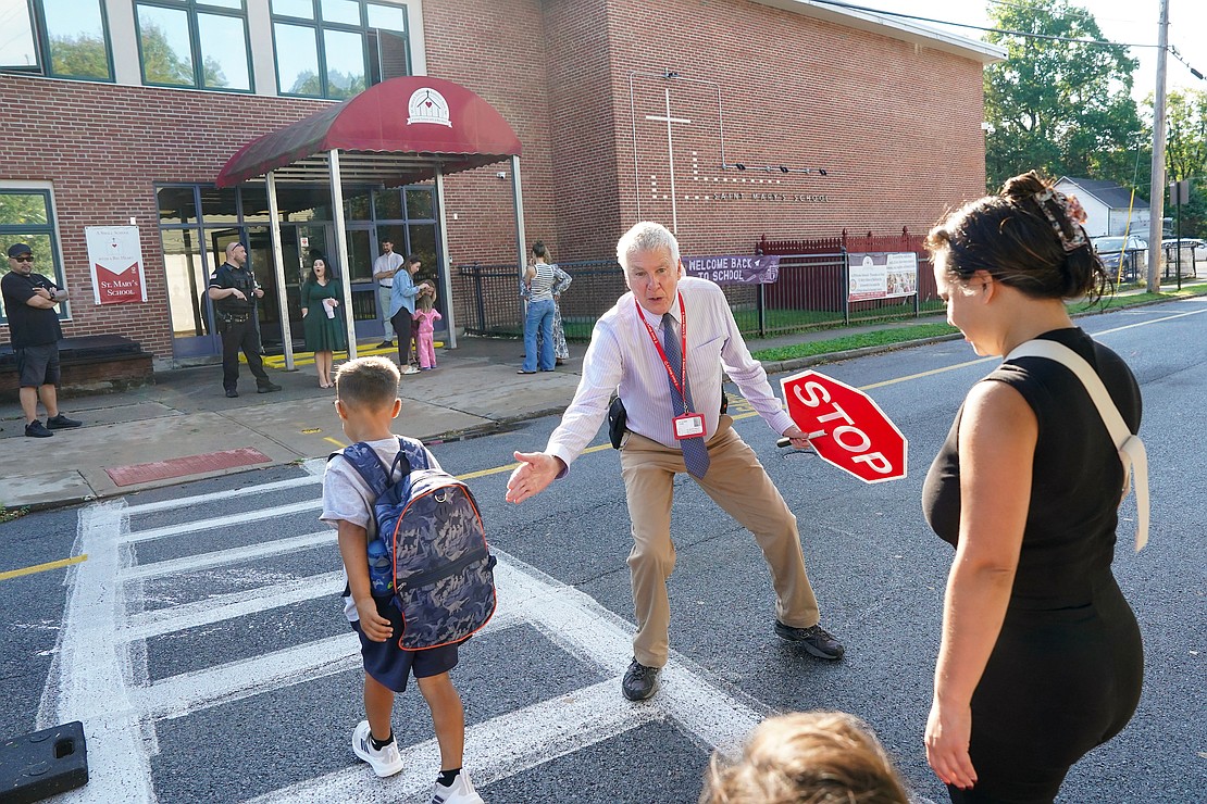 Librarian and Tech teacher Gary Walsh greets students arriving for school as he helps them safely cross the street on Sept. 10 at St. Mary’s School in Ballston Spa. (Cindy Schultz photo for The Evangelist)