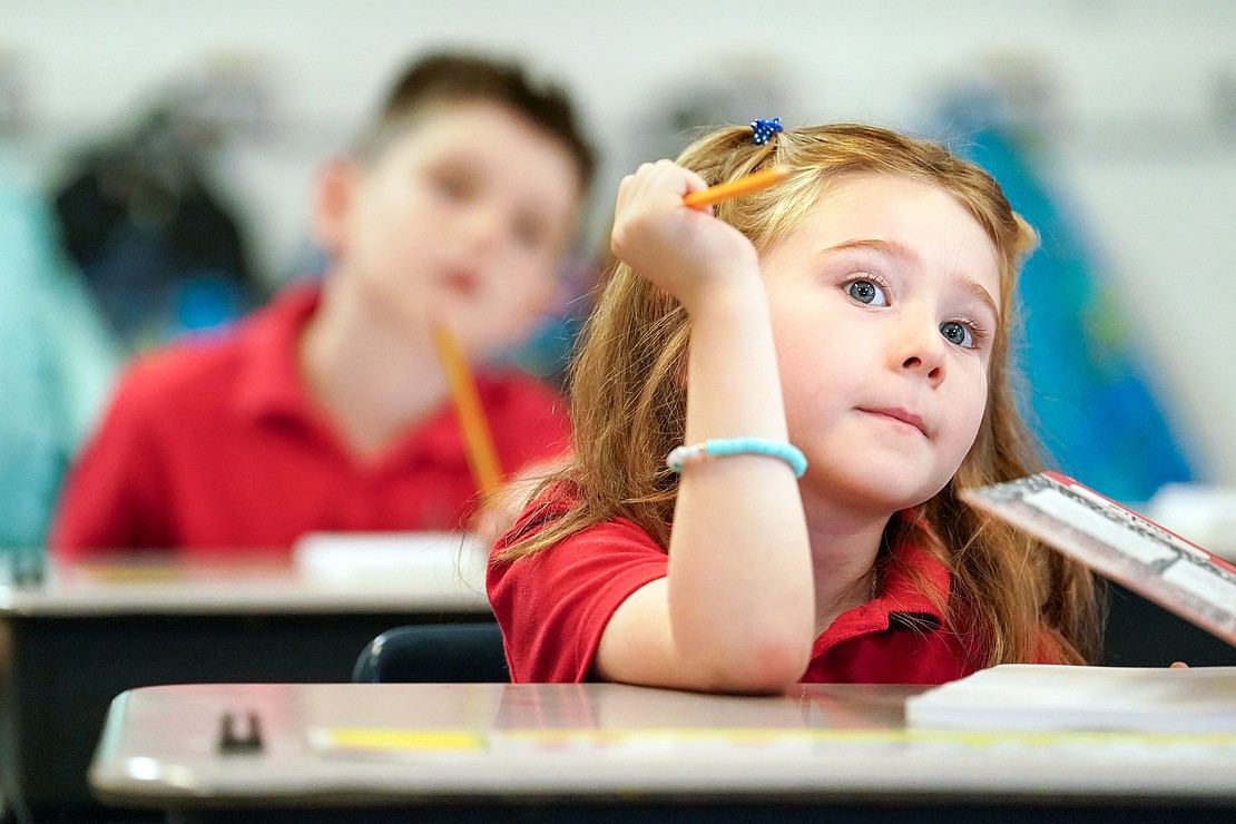 First grader Sadie Northrup stops to think as students write a story in class on Sept. 10 at St. Mary’s School in Ballston Spa. (Cindy Schultz photo for The Evangelist)