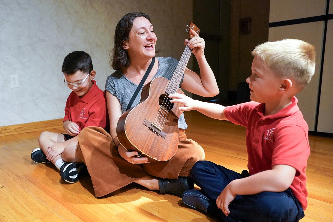 Kindergartners take turns strumming a ukulele while music teacher Lesley O’Donnell teaches them a song on Sept. 10 at St. Mary’s School in Ballston Spa. (Cindy Schultz photo for The Evangelist)