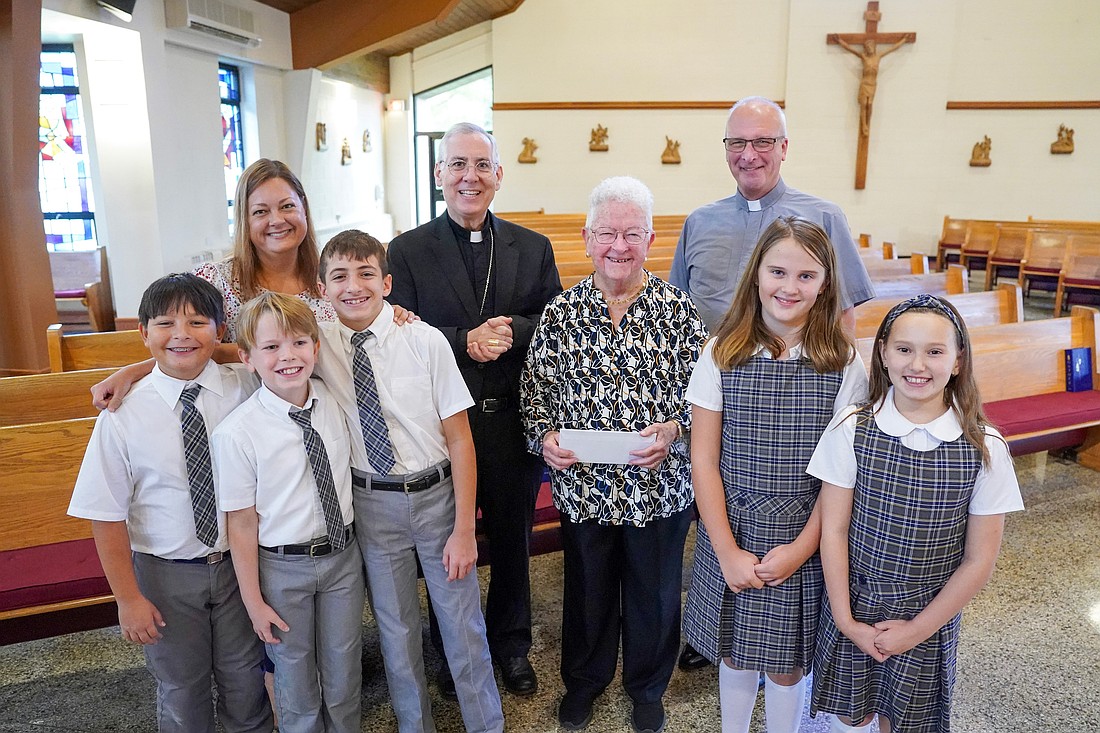 Principal Alexandra Morazan of St. Mary’s School in Waterford (back l.) and some of her students join Bishop Mark O’Connell, Mary Ellen Doyle Sochor and Deacon Andy Grebe for a picture during the Father Kenneth J. Doyle Catholic Education Fund awards ceremony on Sept. 30 at St. Mary’s, Crescent in Waterford. (Cindy Schultz photo for The Evangelist)