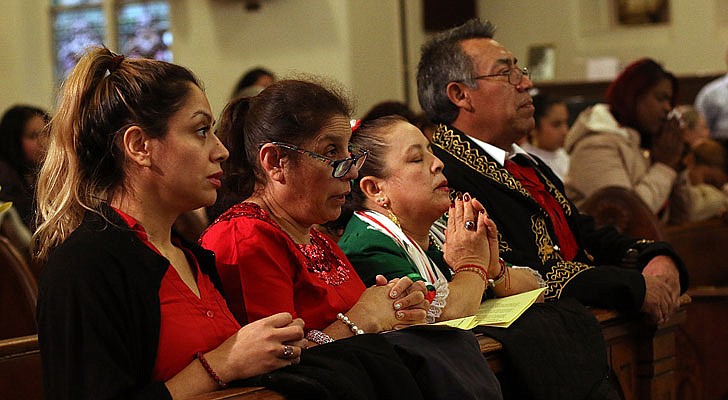 The Shrine Church of Our Lady of the Americas in Albany celebrated a Mass honoring Our Lady of Guadalupe with Bishop Edward B. Scharfenberger on Sunday, Dec. 15. According to CNS, “Our Lady of Guadalupe appeared to St. Juan Diego on Tepeyac Hill near Mexico City on Dec. 9 and Dec. 12, 1531, saying she wanted a church built in her honor on that hill. The bishop, who originally ignored Juan Diego, asked for a sign from her and Mary produced enough roses in December to fill his tilma, a type of outer garment. When he emptied the cloak and the roses fell in front of the bishop, he found that she had left her image on the cloak, which remains today in the Basilica of Our Lady of Guadalupe in Mexico City.” The feast day of Our Lady of Guadalupe is Dec. 12.   Worshippers at the Shrine Church of the Americas on Sunday during the Mass honoring Our Lady of Guadalupe.  Photos by Thomas Killips