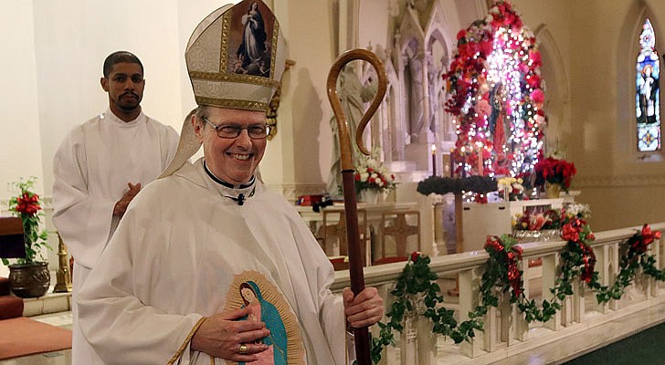 The Shrine Church of Our Lady of the Americas in Albany celebrated a Mass honoring Our Lady of Guadalupe with Bishop Edward B. Scharfenberger on Sunday, Dec. 15. According to CNS, “Our Lady of Guadalupe appeared to St. Juan Diego on Tepeyac Hill near Mexico City on Dec. 9 and Dec. 12, 1531, saying she wanted a church built in her honor on that hill. The bishop, who originally ignored Juan Diego, asked for a sign from her and Mary produced enough roses in December to fill his tilma, a type of outer garment. When he emptied the cloak and the roses fell in front of the bishop, he found that she had left her image on the cloak, which remains today in the Basilica of Our Lady of Guadalupe in Mexico City.” The feast day of Our Lady of Guadalupe is Dec. 12.   Bishop Scharfenberger  leaves the altar after Mass.  Photos by Thomas Killips