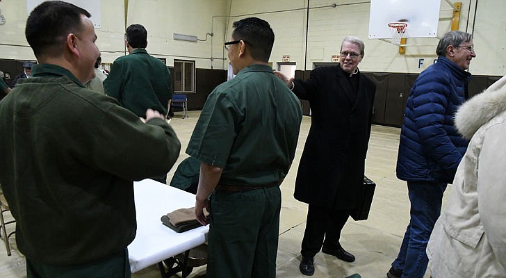 Bishop Edward B. Scharfenberger celebrated a special Christmas Mass for inmates at the Washington Correctional Facility in Comstock on Thursday, Dec. 19. Deacon Miguel Fabian, the facility’s chaplain, Father Rendell Torres and Deacon Ryan McNulty resided over the Mass, which was held in the facility’s gymnasium and attended by 33 inmates.   Bishop Scharfenberger says his goodbyes after Mass.  Michael P. Farrell photos