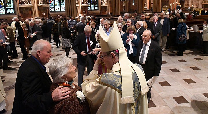 Bishop Scharfenberger greets couples after the annual Marriage Jubilee Mass at the Cathedral of the Immaculate Conception in Albany in October.   Michael P. Farrell photo