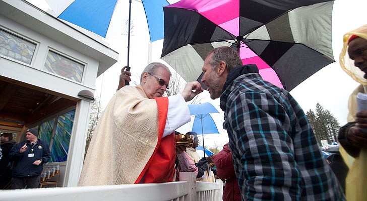 Thousands braved the rain and cold temperatures to attend Mass on Divine Mercy Sunday at the National Shrine of Divine Mercy in Stockbridge, Mass., on Sunday, April 28. Bishop Edward Scharfenberger celebrated the Mass, blesses the crowd with the heart of St. John Vianney, the patron saint of parish priests, and gives out communion along with other priests. Divine Mercy is based on St. Faustina Kowalska’s visions and conversations she had with Jesus Christ, who asked St. Faustina to paint the vision of Divine Mercy. Divine Mercy Sunday is the first Sunday after Easter.   Nate Whitchurch photo