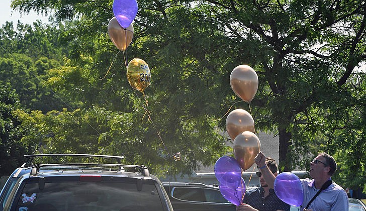 Scenes from Christian Brothers Academy’s graduation at the football stadium on Thursday in which 88 seniors graduated.  Tom Rollo, along with one of his sons, Alex, decorate their car for his other son and graduate, Jonathan.  (Photos by Michael P. Farrell)