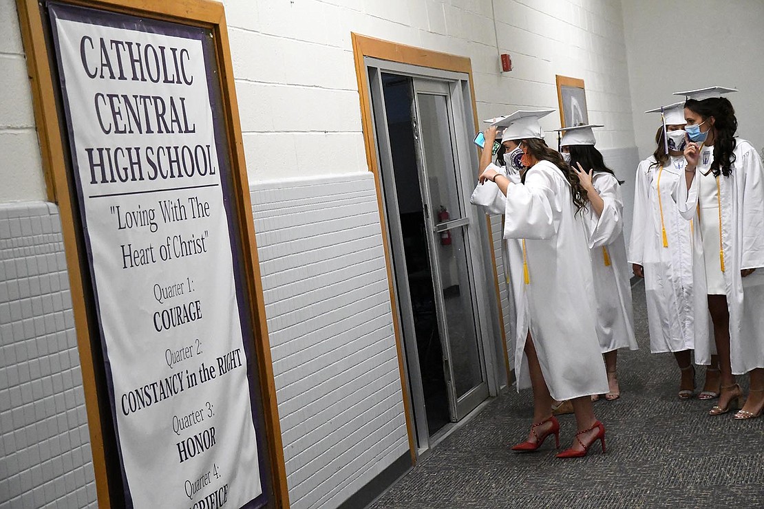 Catholic Central High School in Troy held its 97th Commencement Exercises on Saturday, July 25, under a tent at the athletic fields. The school graduated 40 seniors, including Valedictorian Paul Barber and Salutatorian Michael J. Paglia. Bishop Edward B. Scharfenberger presided and blessed the graduates.  Graduates get ready prior to commencement.  Photos by Michael P. Farrell 