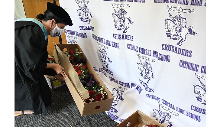 Catholic Central High School in Troy held its 97th Commencement Exercises on Saturday, July 25, under a tent at the athletic fields. The school graduated 40 seniors, including Valedictorian Paul Barber and Salutatorian Michael J. Paglia. Bishop Edward B. Scharfenberger presided and blessed the graduates.  Counselor Aileen Ryan gathers roses for female graduates.  Photos by Michael P. Farrell 