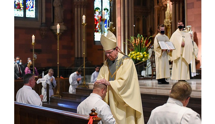 The combined Priesthood Ordination Rite and Diaconate Ordination Rite was celebrated by Bishop Edward B. Scharfenberger, with one man ordained to the priesthood and 13 men ordained to the Diaconate - eight men to the Permanent Diaconate and five men to the Transitional Diaconate - on Sept. 5 at the Cathedral of the Immaculate Conception in Albany.   Bishop Scharfenberger lays his hands on each deacon.  Photos by Cindy Schultz 