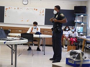 Albany police officer, a Maginn grad, connects with social justice class