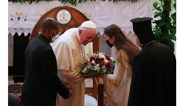 Pope Francis arrived in Baghdad, Iraq on Friday for his historic four-day visit to the Middle East nation. It is the first time a pope has ever visited Iraq and Pope Francis’ first foreign trip in 15 months because of the COVID-19 pandemic. The visit was to promote peace, tolerance and equality in the troubled nation.   Caption: Pope Francis accepts flowers during a meeting with bishops, priests, religious men and women, seminarians and catechists in the Syriac Catholic Cathedral of Our Lady of Deliverance in Baghdad on March 5. (CNS photo/Paul Haring)