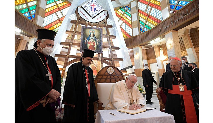 Pope Francis arrived in Baghdad, Iraq on Friday for his historic four-day visit to the Middle East nation. It is the first time a pope has ever visited Iraq and Pope Francis’ first foreign trip in 15 months because of the COVID-19 pandemic. The visit was to promote peace, tolerance and equality in the troubled nation.   Caption: Pope Francis signs a book with a message for Syriac Catholics at the Cathedral of Our Lady of Deliverance in Baghdad on March 5. Also pictured, from left: Syriac Catholic Patriarch Ignace Joseph III Younan, Syriac Catholic Archbishop Ephrem Yousif Mansoor Abba of Baghdad and Chaldean Patriarch Louis Sako of Baghdad. (CNS photo/Vatican Media via Reuters)