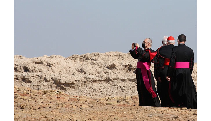 Archbishop Edgar Pena Parra takes a photo as a Vatican delegation tours what is believed to be the home of Abraham at the ruins of the ancient city of Ur before Pope Francis' interreligious meeting on the plain of Ur near Nasiriyah, Iraq, March 6, 2021. (CNS photo/Vatican Media)