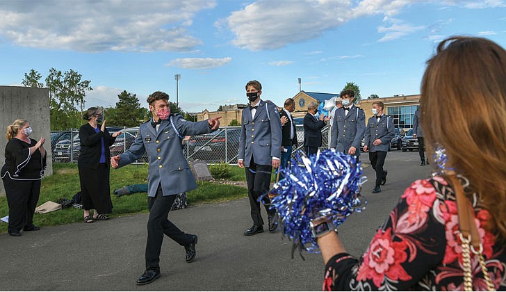 La Salle Institute in Troy held its graduation ceremony for its senior class on May 14 at its turf field. Dr. Chris Gibson, president of Siena College, decorated Army officer and a former member of the U.S. House of Representatives, was the keynote speaker. The 60 members of the class of 2021 were collectively accepted to 117 colleges and universities in 21 states and the District of Columbia and earned 163 scholarships totaling more than $11.9 million over four years. To remain compliant and adhering to all CDC and NYS guidelines, attendance was invite-only and the ceremony was livestreamed to accommodate those unable to attend in person.   Caption: Graduate Avery Luther, in front of the line, acknowledges teachers and staff lining the entrance to the commencement exercises.  Cindy Schultz photos  